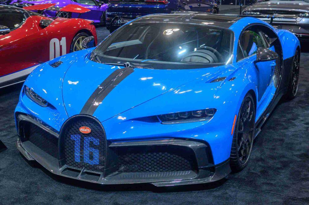 Blauer Bugatti Chiron 2025 mit Carbon-Elementen auf einer Automesse als Beispiel für die Kfz-Versicherung eines hochpreisigen Luxusfahrzeugs.